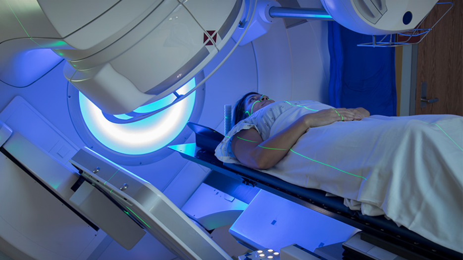 Woman receiving radiation therapy for cancer treatment.